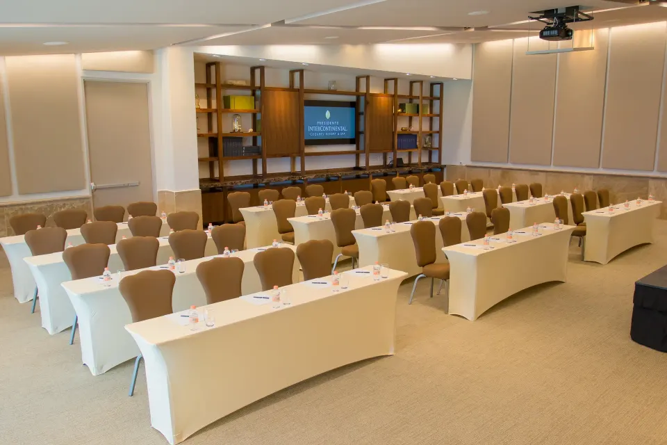 Classroom-style meeting room with rows of tables and chairs at InterContinental Presidente Cozumel Resort Spa