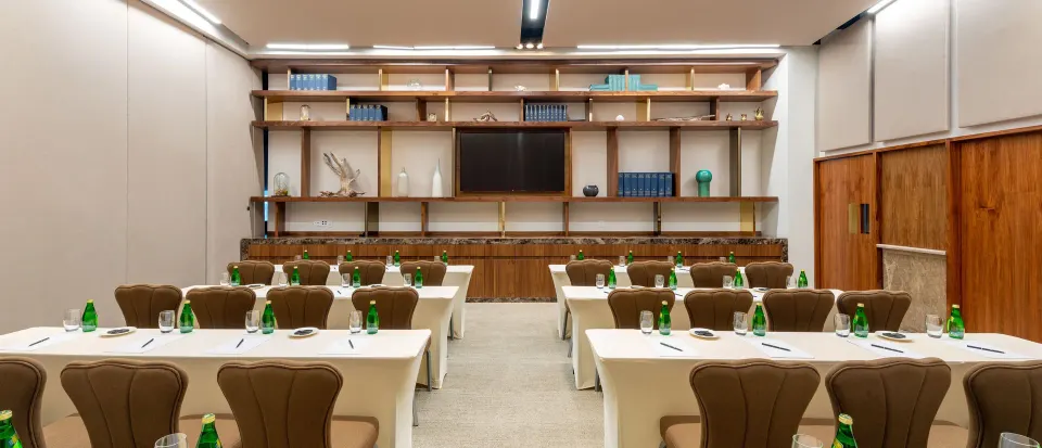 Conference room with rows of tables and bottled water ready for attendees at InterContinental Presidente Cozumel Resort Spa