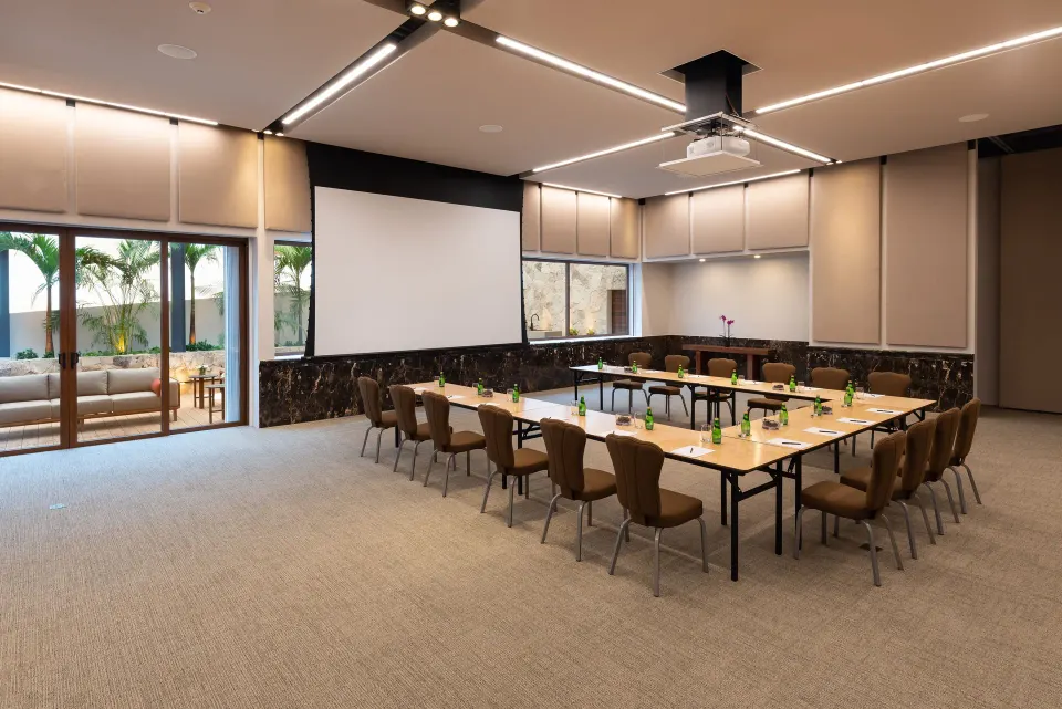Large meeting room with projector screen and U-shaped tables at InterContinental Presidente Cozumel Resort Spa
