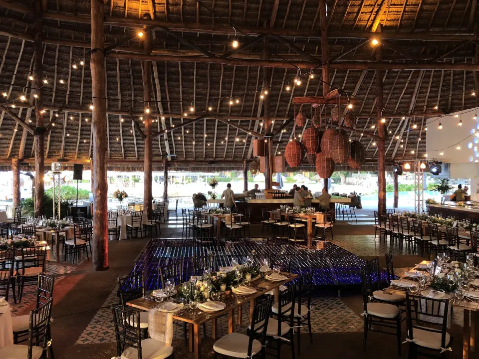 Large palapa-style event dining area set with tables and lights at InterContinental Presidente Cozumel Resort Spa