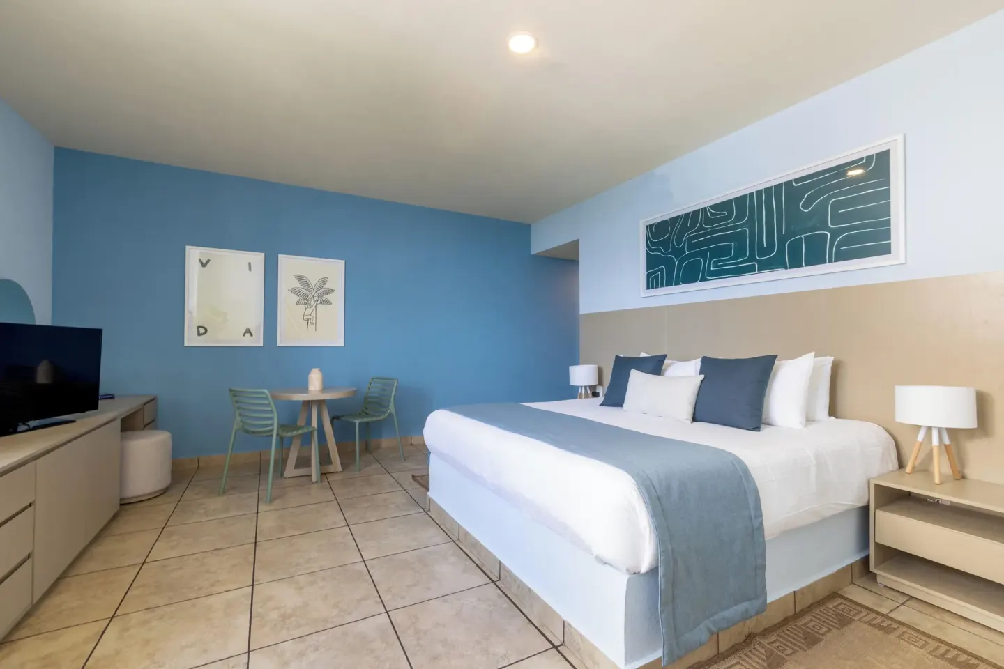Standard Room at Ixchel Beach Hotel with one bed, TV console, and dining table.