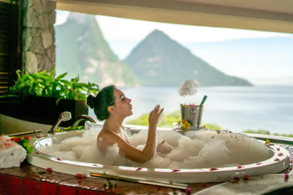 Guest in a bubble bath with Piton views at Jade Mountain Resort.