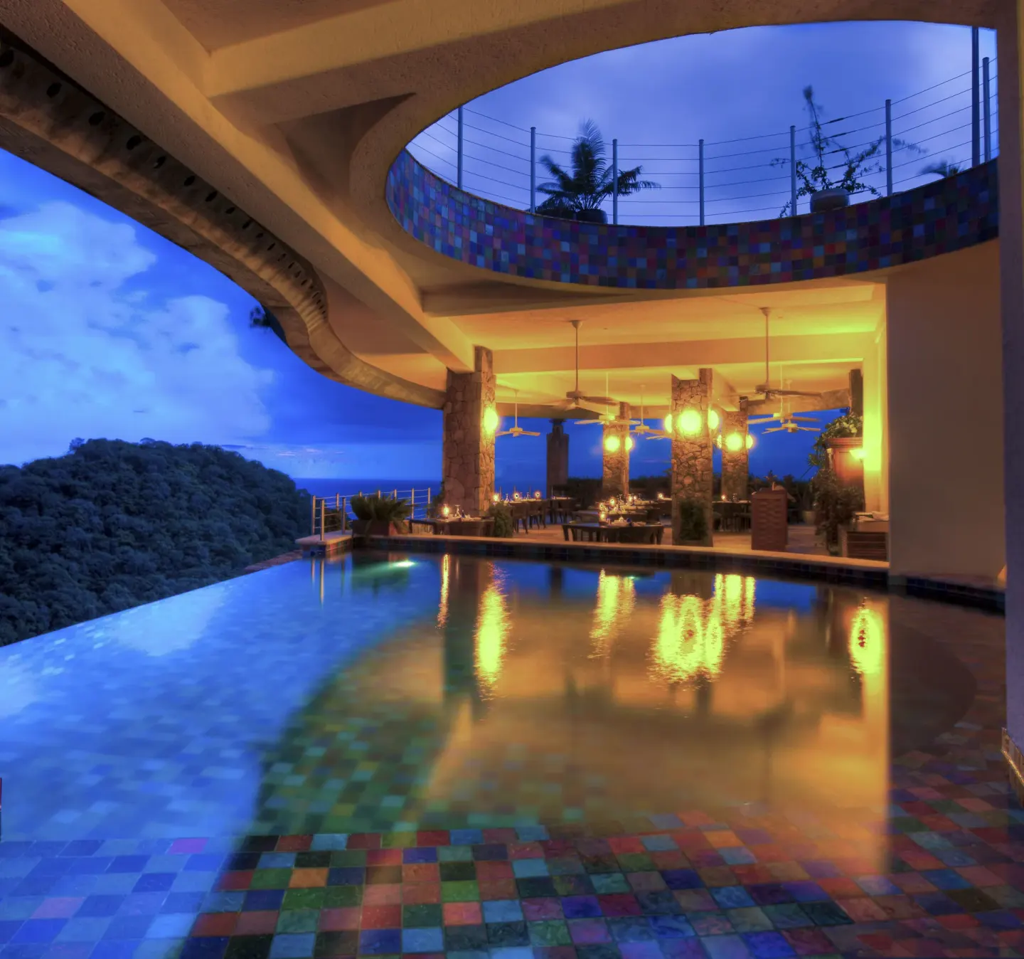 Infinity pool and open-air dining terrace at dusk at Jade Mountain Resort.