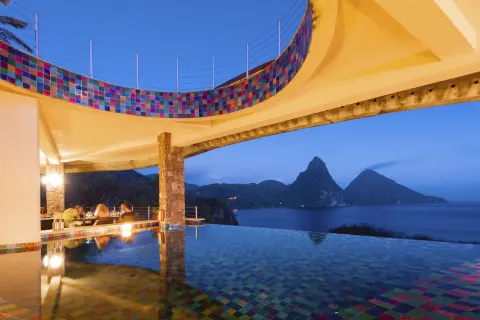 Infinity pool with colorful tile and Piton views at dusk at Jade Mountain Resort.