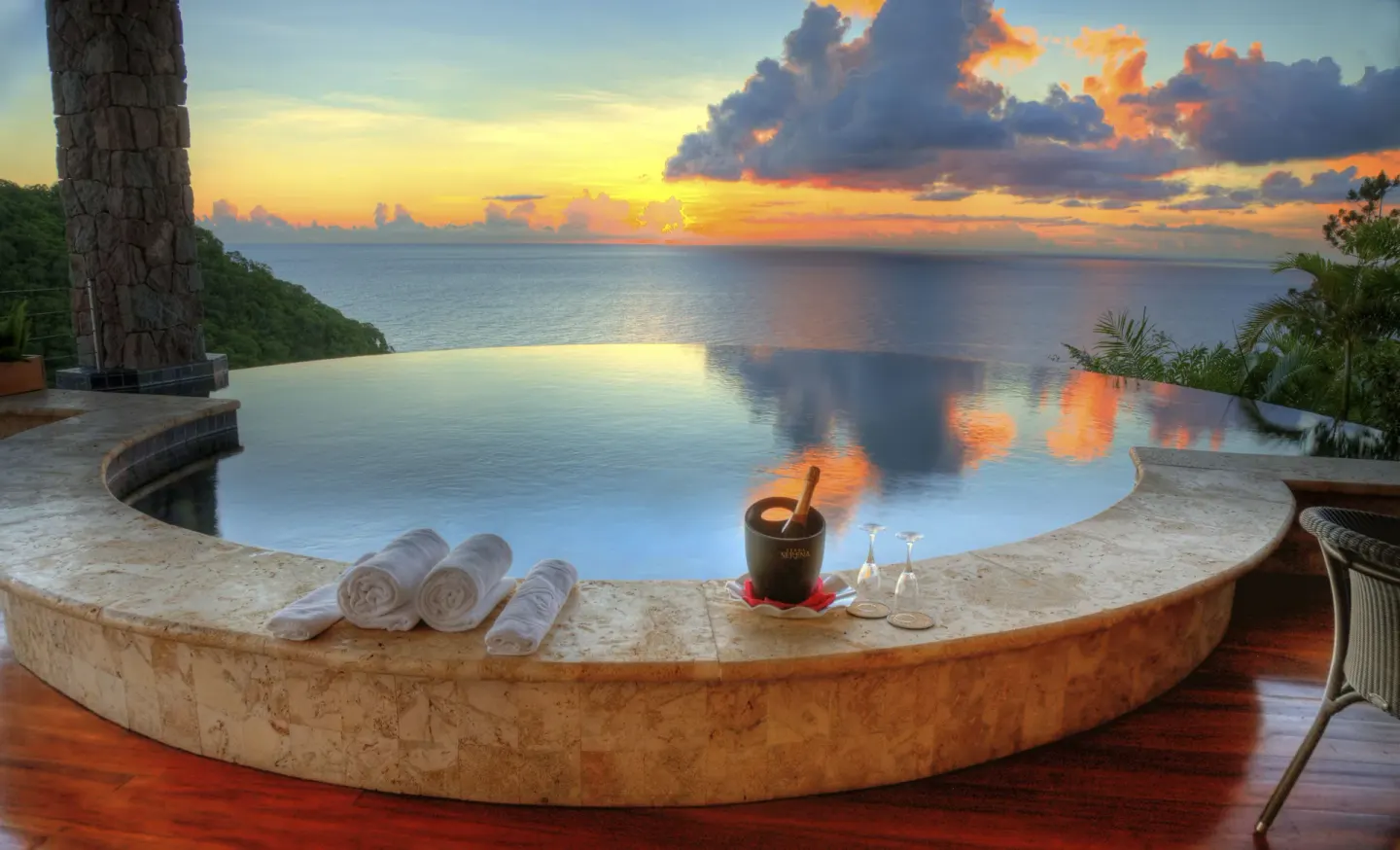 An infinity pool reflects sunset clouds at Jade Mountain Resort.