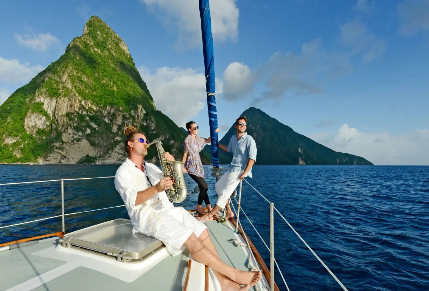 Guests relax on a sailboat with the Pitons in view near Jade Mountain Resort.