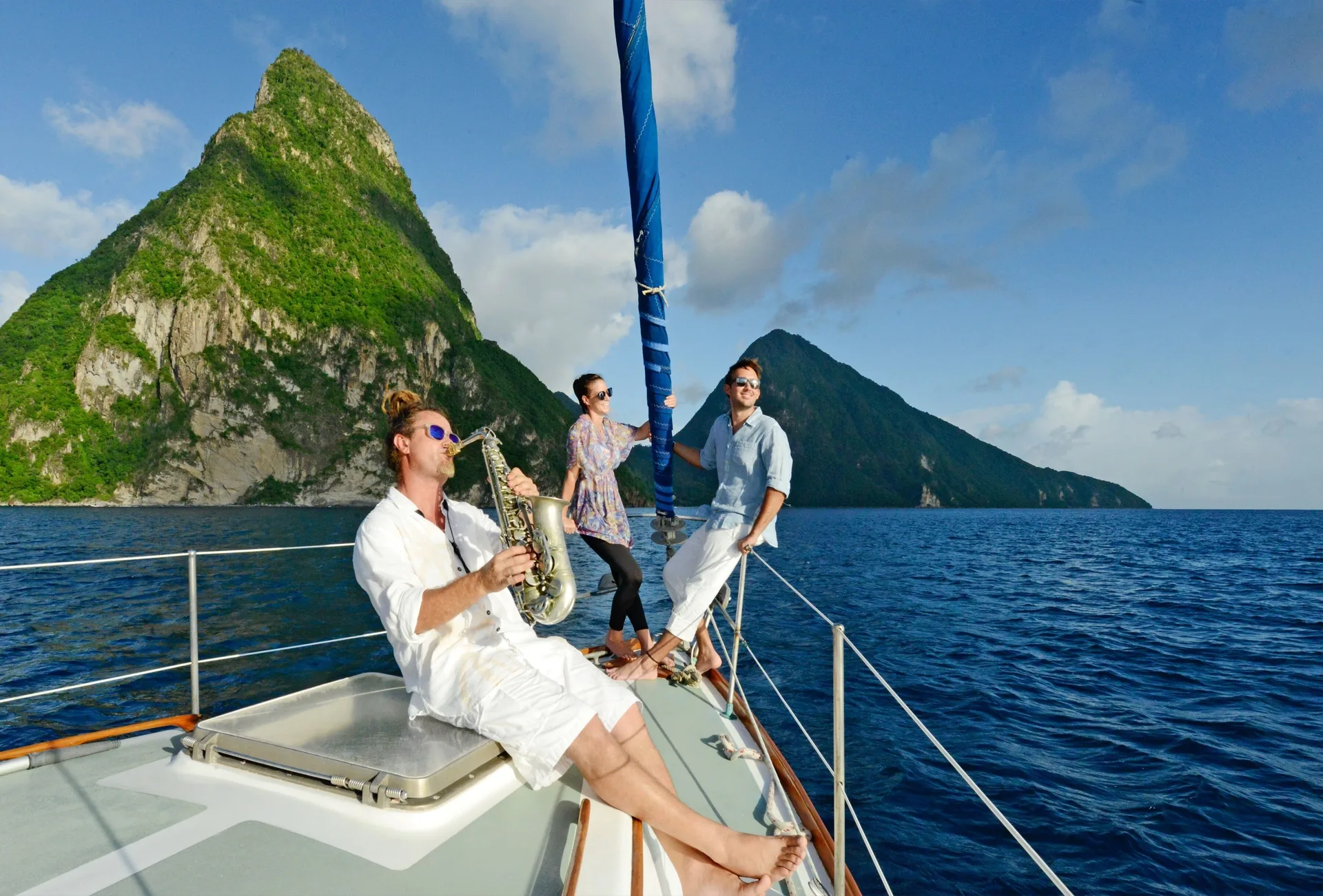 Guests relax on a sailboat with the Pitons in view near Jade Mountain Resort.