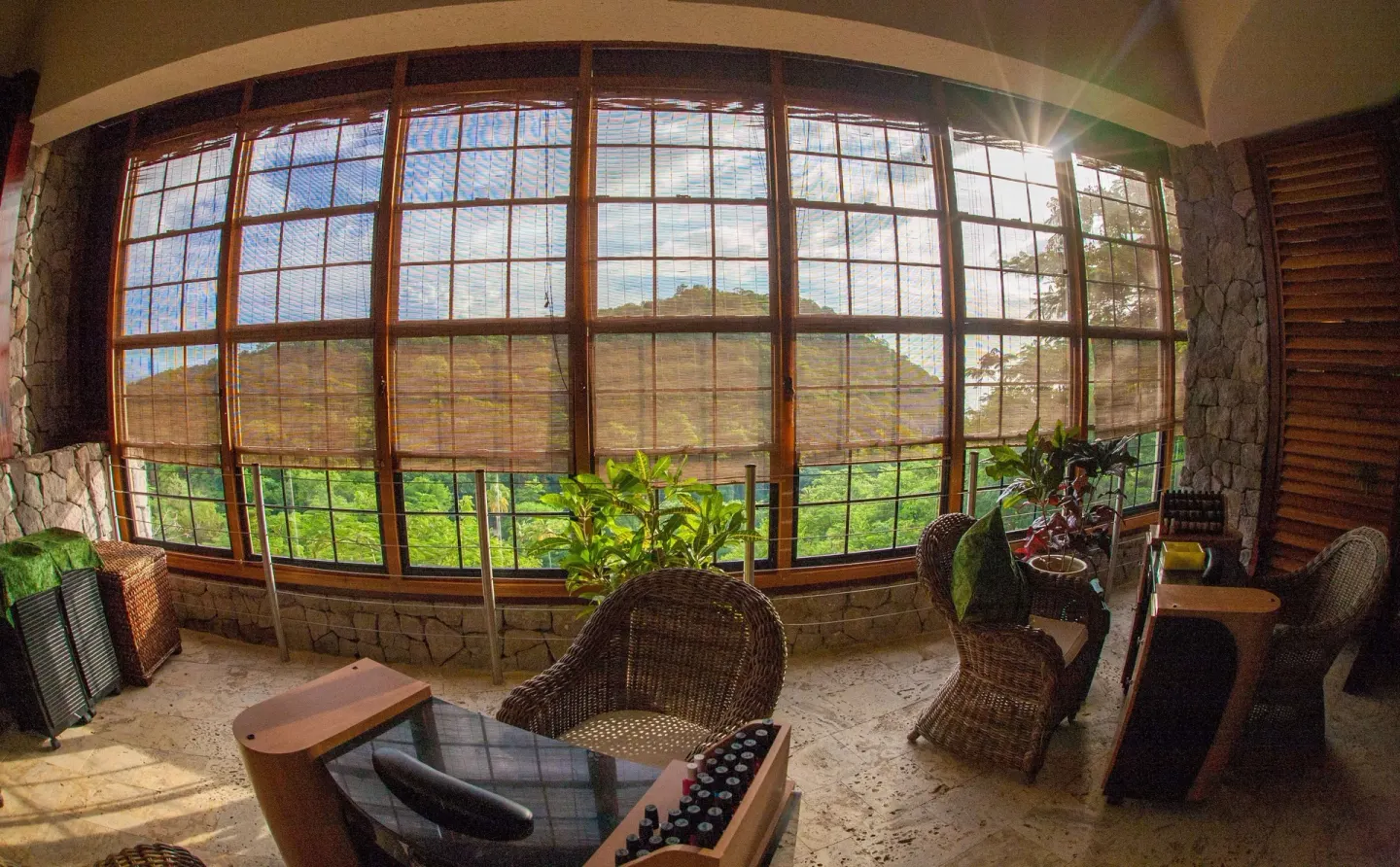 Spa or salon seating area with large windows and greenery at Jade Mountain Resort.