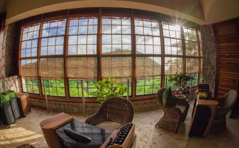 Spa or salon seating area with large windows and greenery at Jade Mountain Resort.