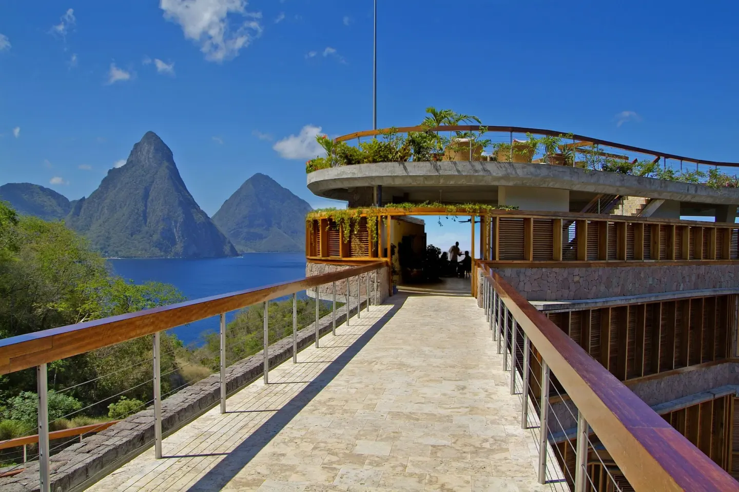 Stone walkway leading to an open building with Piton views at Jade Mountain Resort.