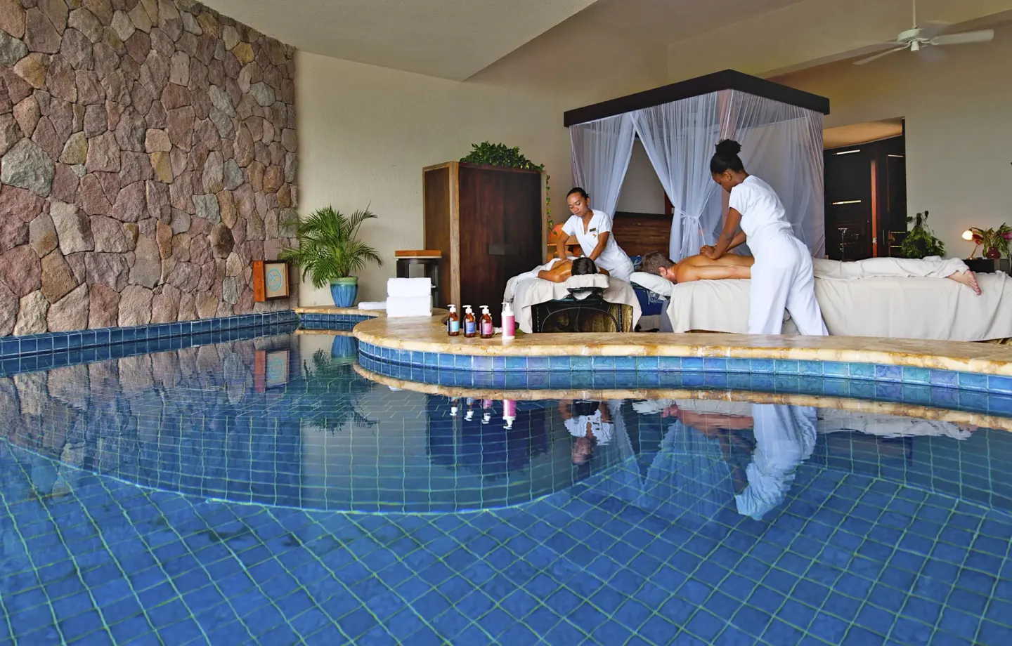 Moon Suite massage setup beside the pool and canopy bed at Jade Mountain Resort.