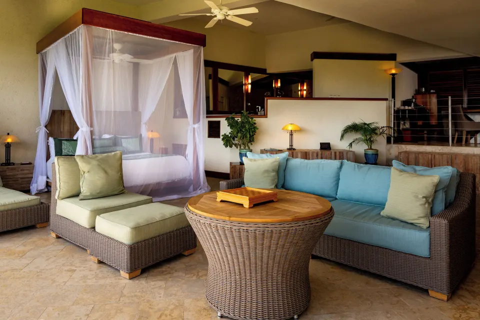 Sky Suite bedroom with canopy bed and lounge seating at Jade Mountain Resort.