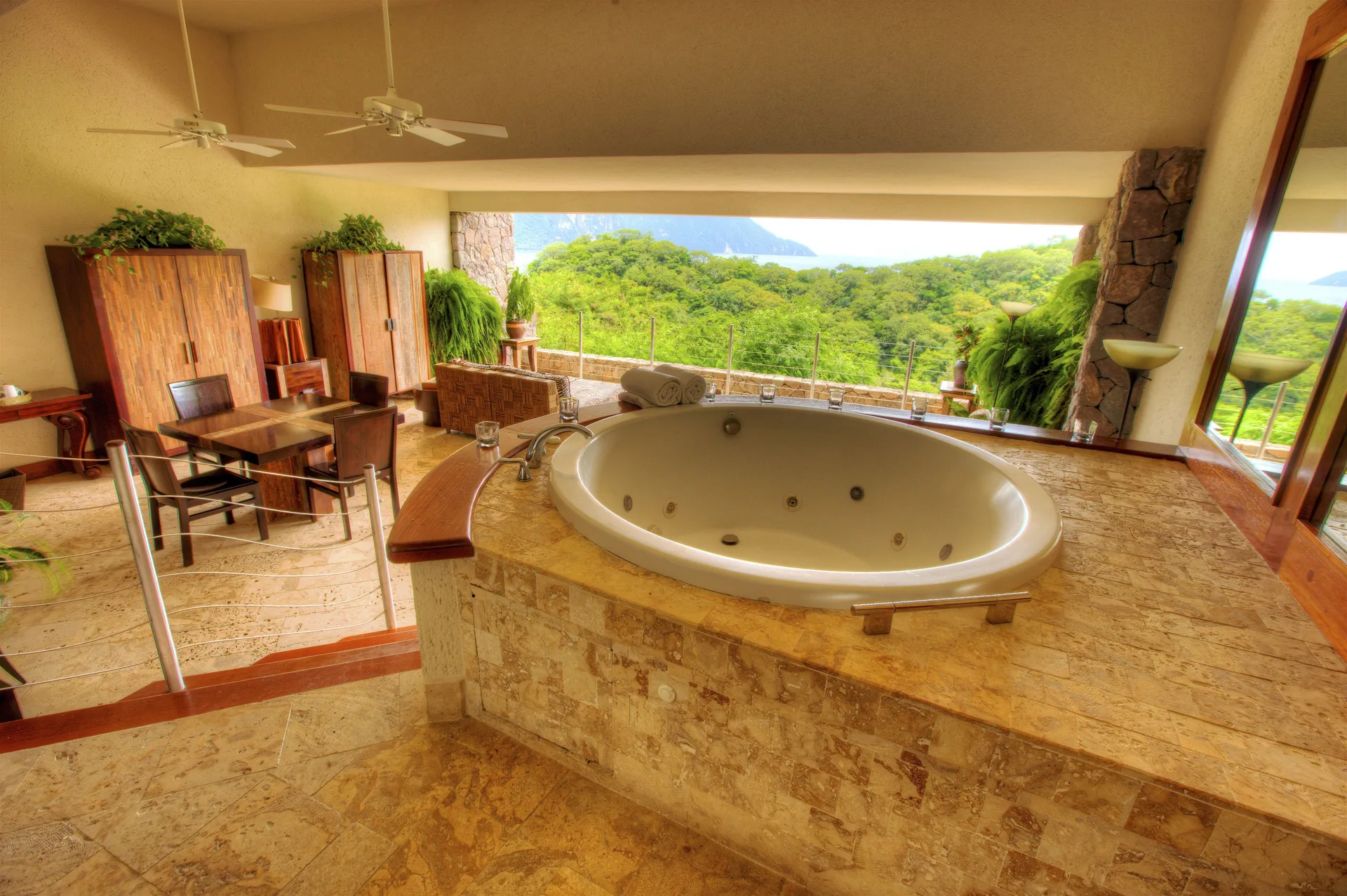 Sky Suite soaking tub and dining area with hillside view at Jade Mountain Resort.