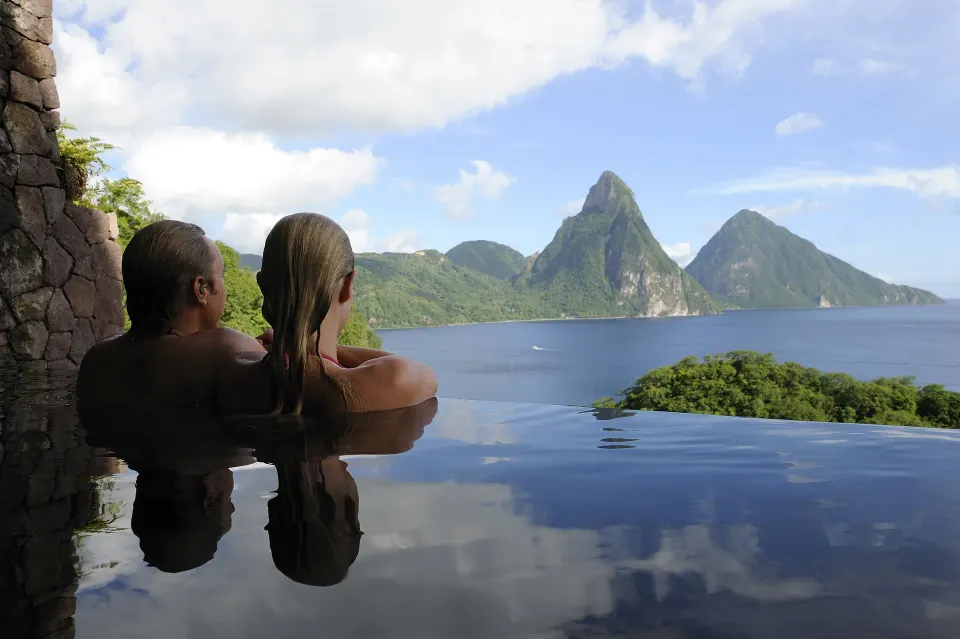 Couple in a Star suite infinity pool facing the Pitons at Jade Mountain Resort.