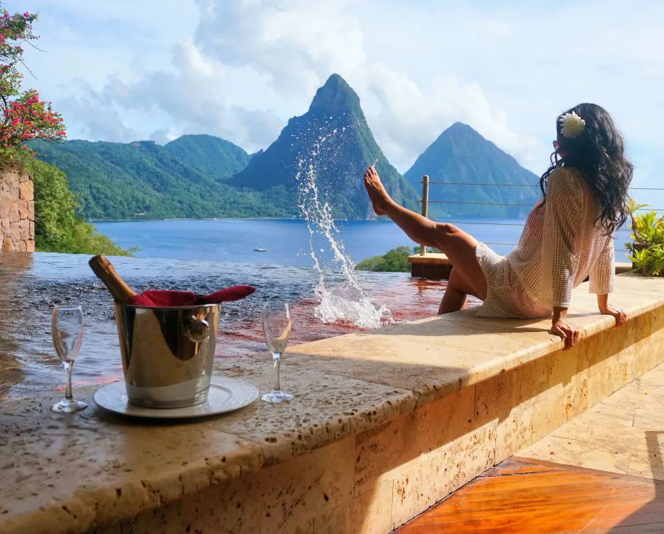 Guest on the Star suite pool edge splashing water at Jade Mountain Resort.