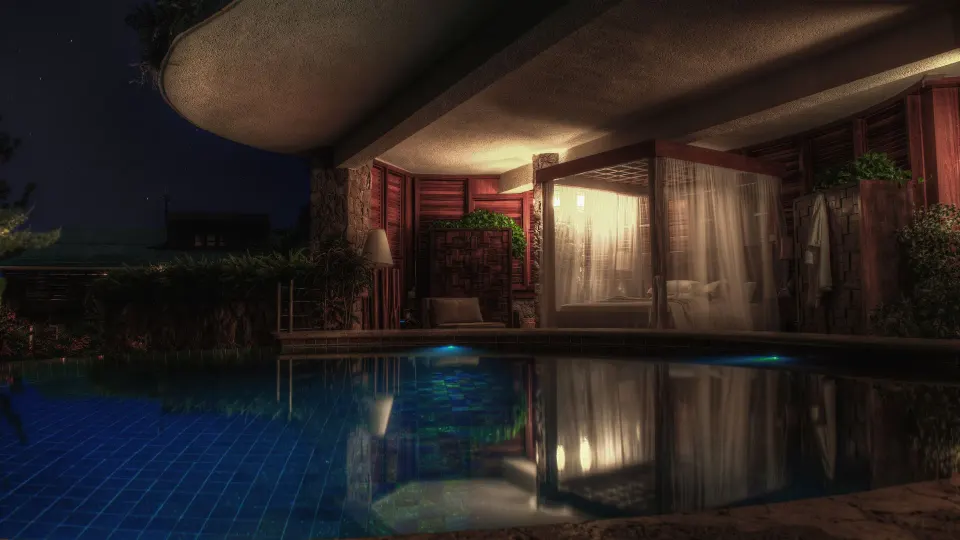 Sun suite at night with canopy bed beside private pool at Jade Mountain Resort.