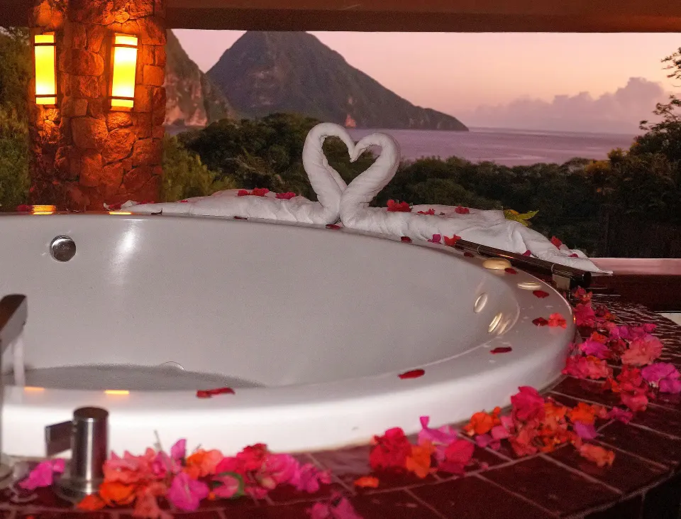 Sun suite bath with flower petals and towel swans at Jade Mountain Resort.