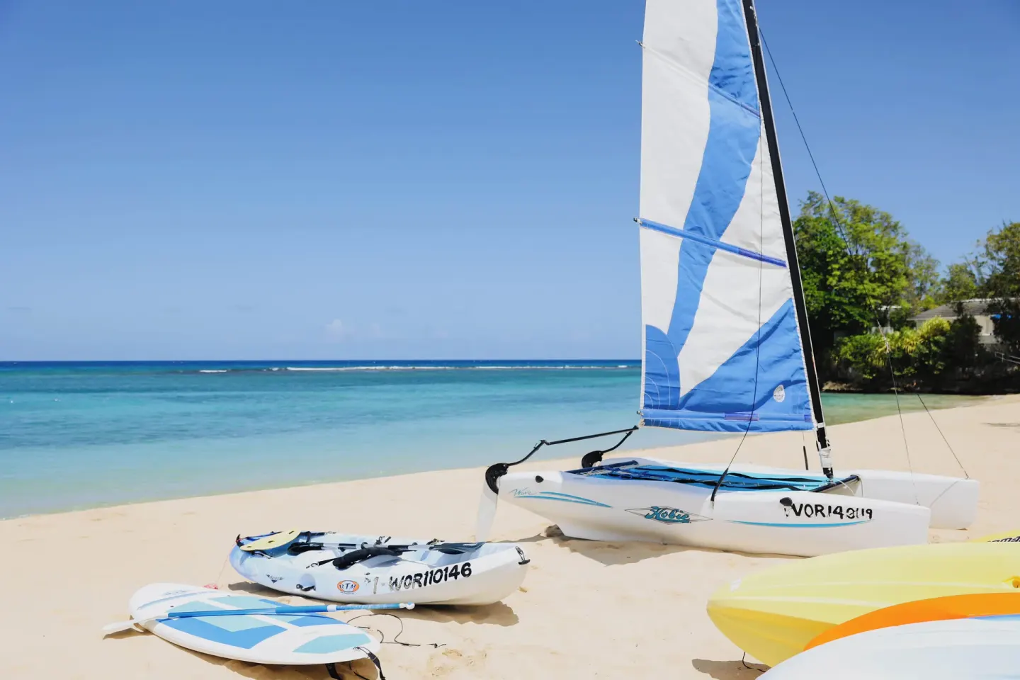Sailboats and boards are lined up on the beach at Jamaica Inn.