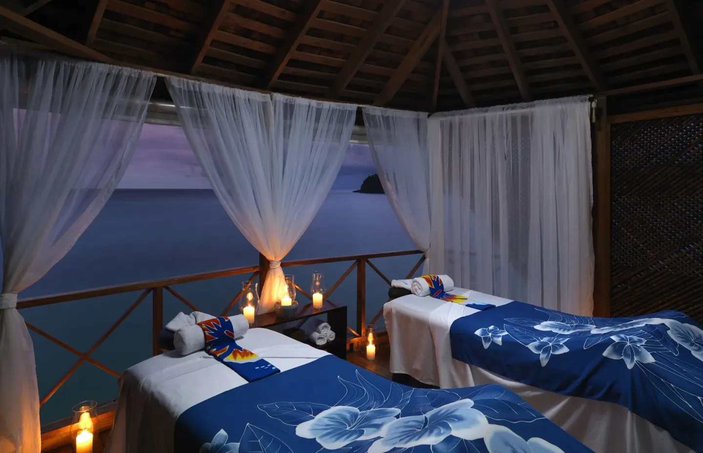 Candlelit spa treatment beds overlooking the sea at Jamaica Inn.