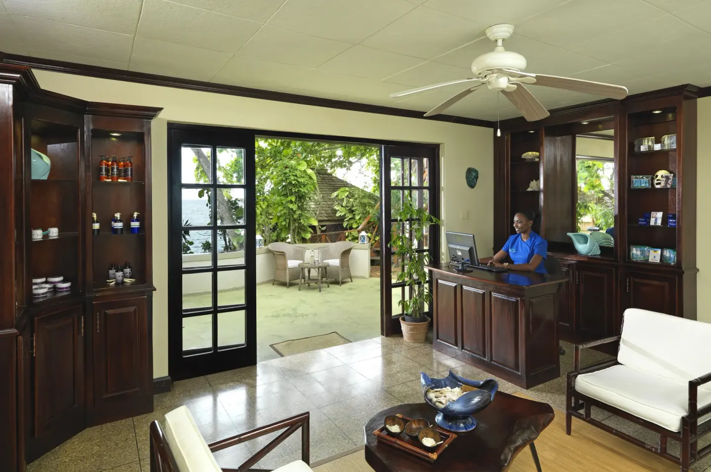 Spa reception room with dark wood cabinetry at Jamaica Inn.