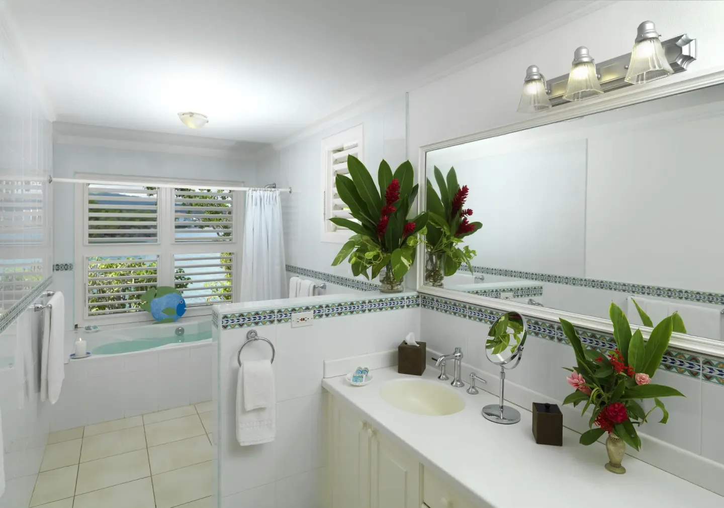 White bathroom with vanity, bathtub, flowers, and louvered ocean-facing windows at Jamaica Inn.