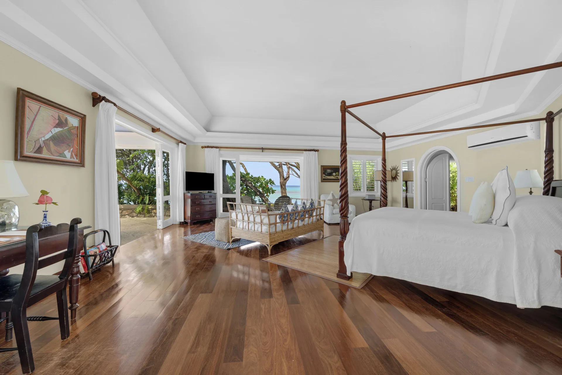 Cottage king bed and sitting area at Jamaica Inn with classic furnishings and beachfront Cottage charm in Ocho Rios.