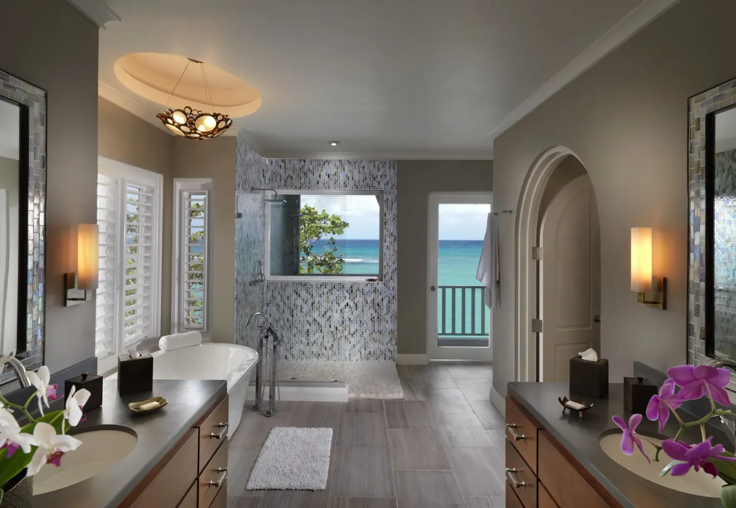Cottage Seven bathroom with twin vanities, tub, shower, and sea view at Jamaica Inn.