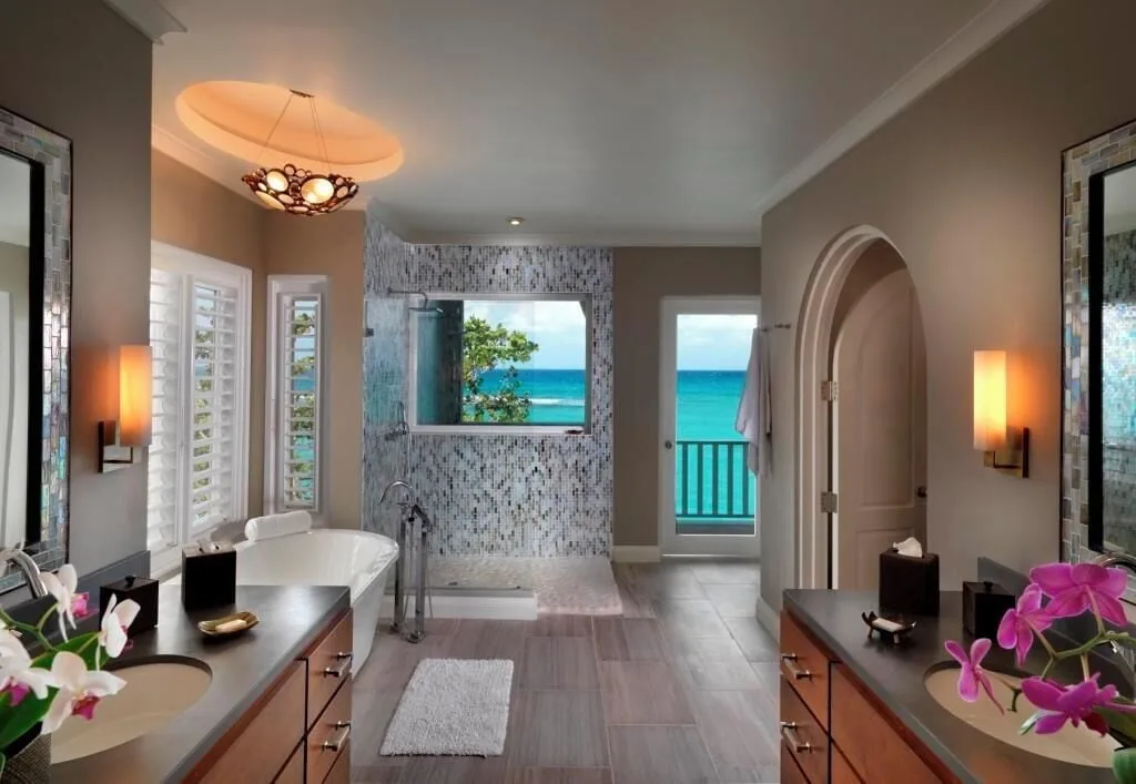 Cottage Seven bathroom with soaking tub, mosaic shower, and ocean view at Jamaica Inn.