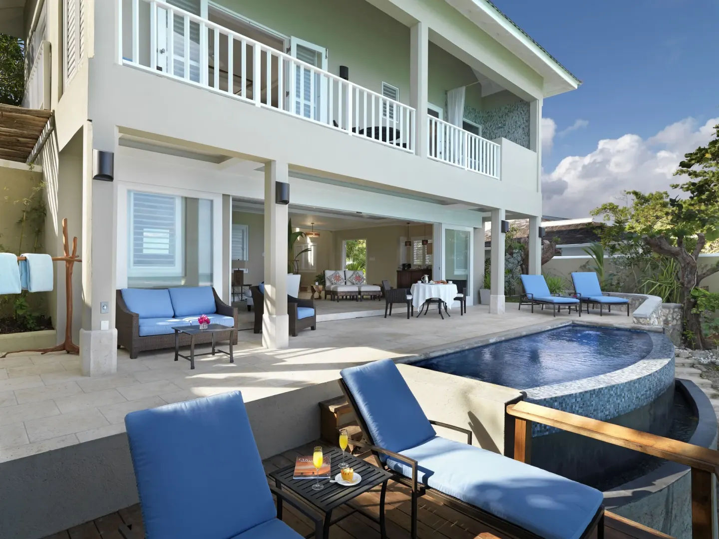 Cottage Seven exterior with balconies, pool, loungers, and patio dining at Jamaica Inn.