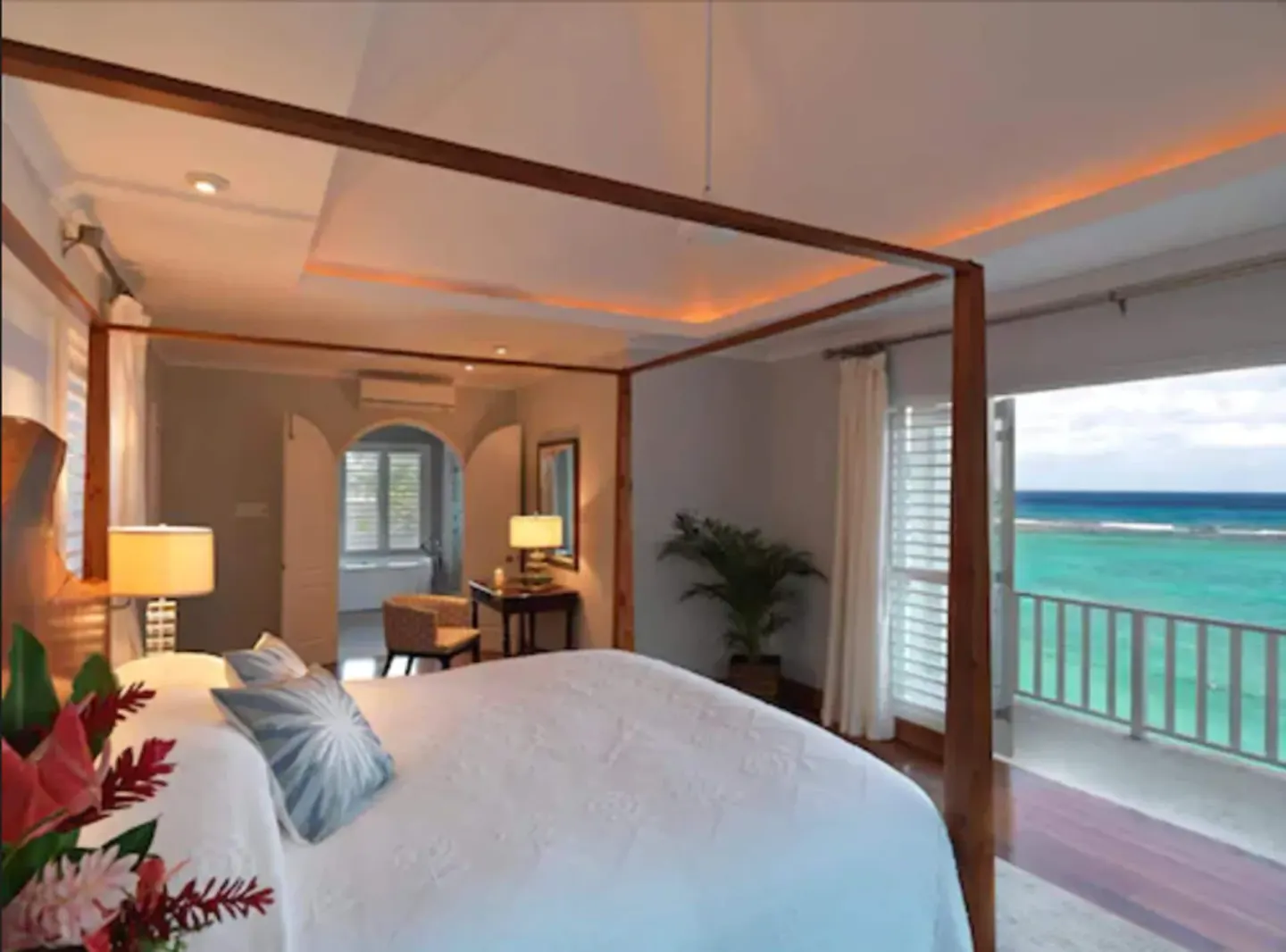Cottage Seven bedroom with four-poster bed and ocean balcony at Jamaica Inn.