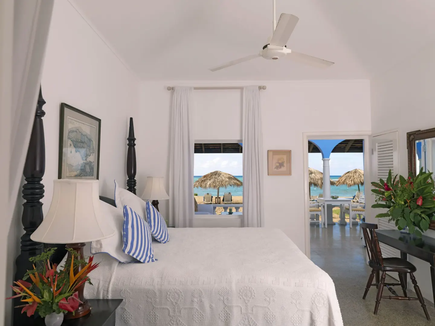Premier Suite bedroom with four-poster bed and verandah view at Jamaica Inn.
