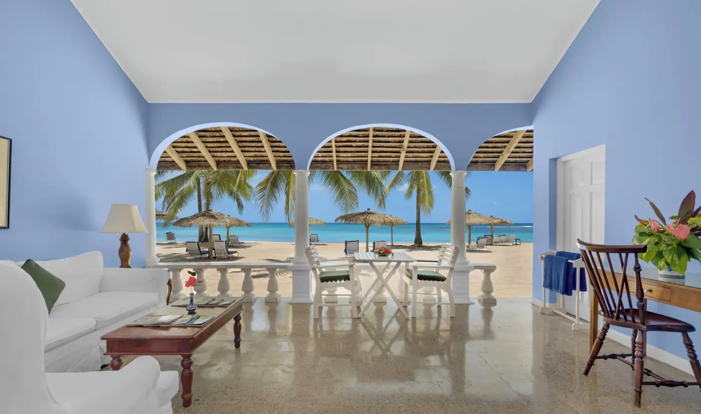 Premier Suite verandah with blue walls and beachfront seating at Jamaica Inn.