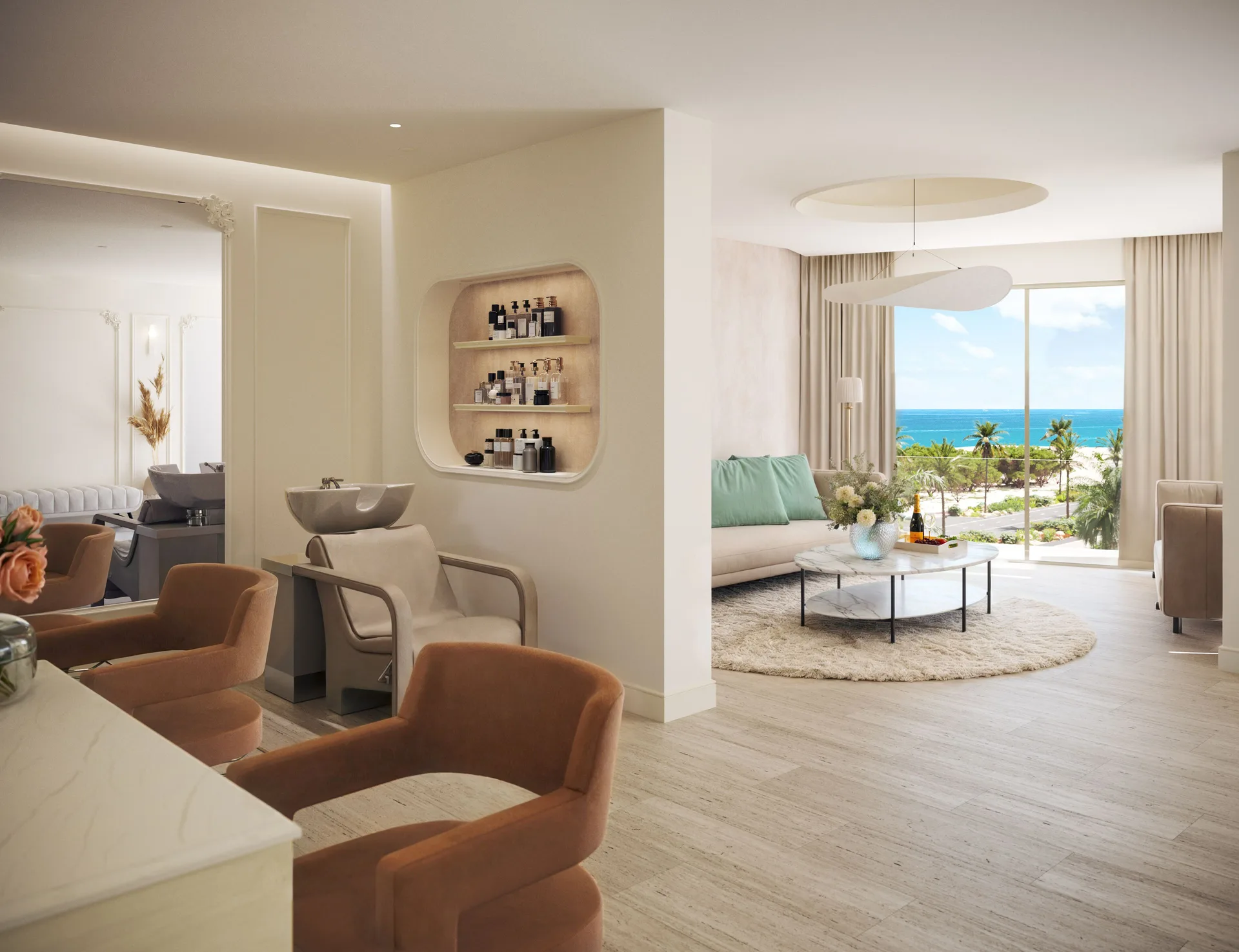 A salon-style lounge with wash stations opens toward an ocean view at JOIA Aruba.
