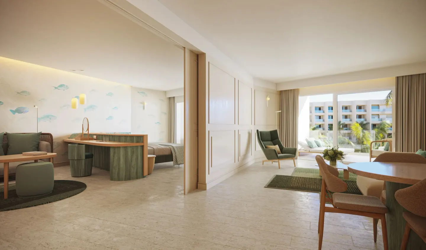 Royal Suite Oceanfront living and bedroom areas at JOIA Aruba with dining table and balcony light.