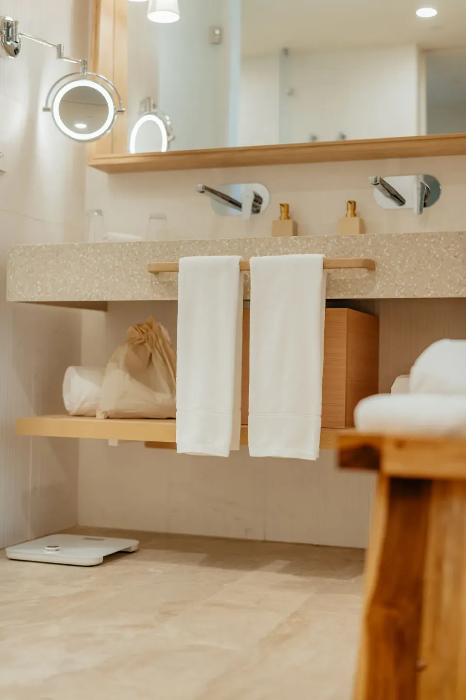 Oceanfront suite bathroom vanity with mirrors, towels, and sinks at JOIA Aruba.