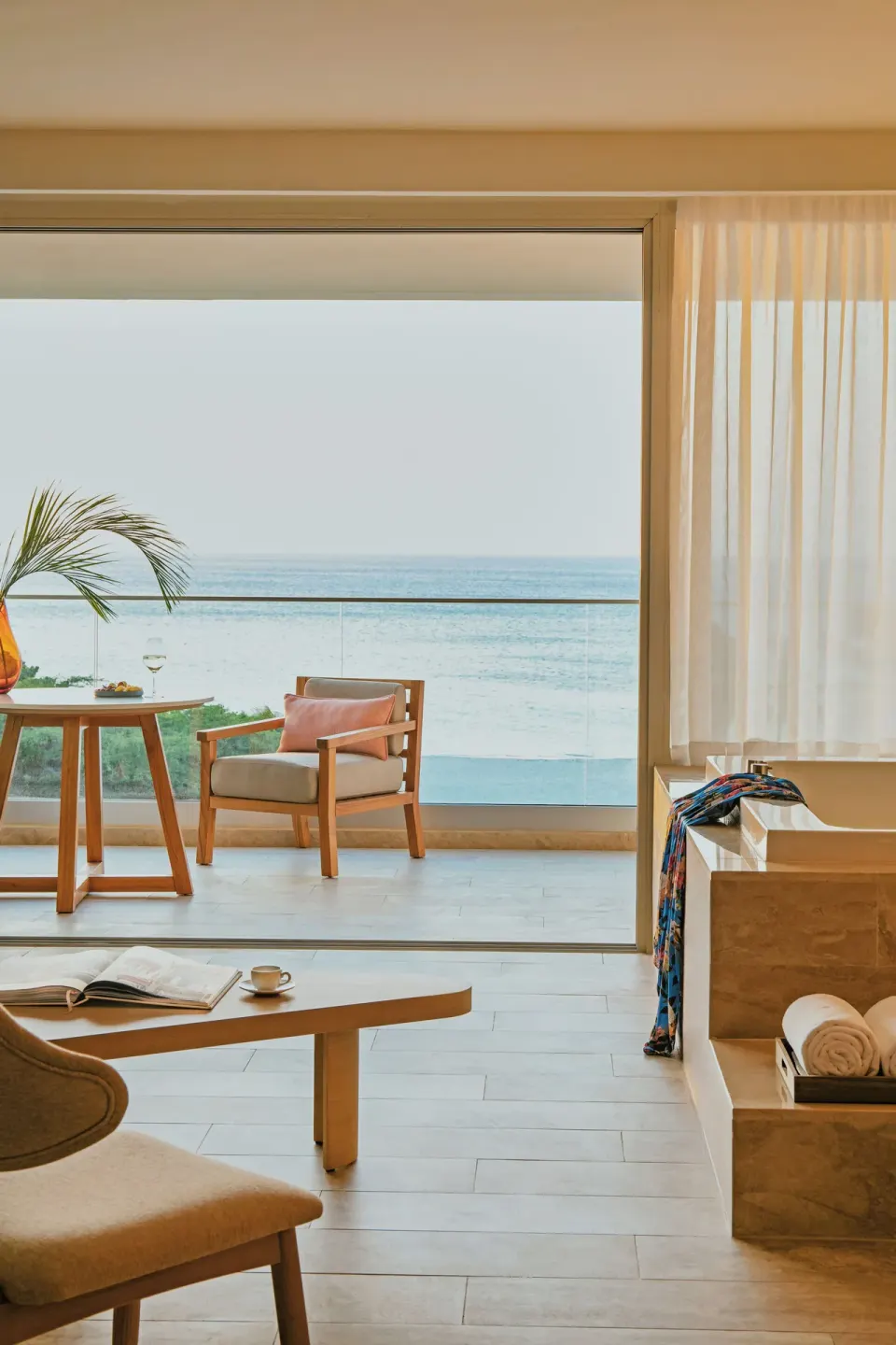 Oceanfront suite terrace and sea view seen from the living area at JOIA Aruba.