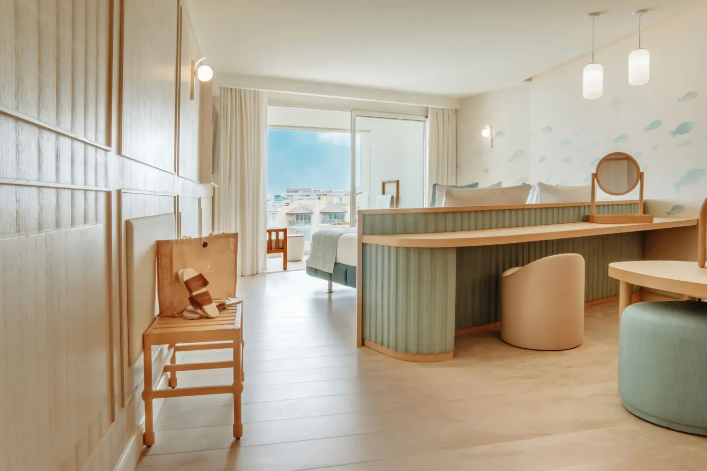 Pool View Suite seating and vanity area leading to the balcony at JOIA Aruba.