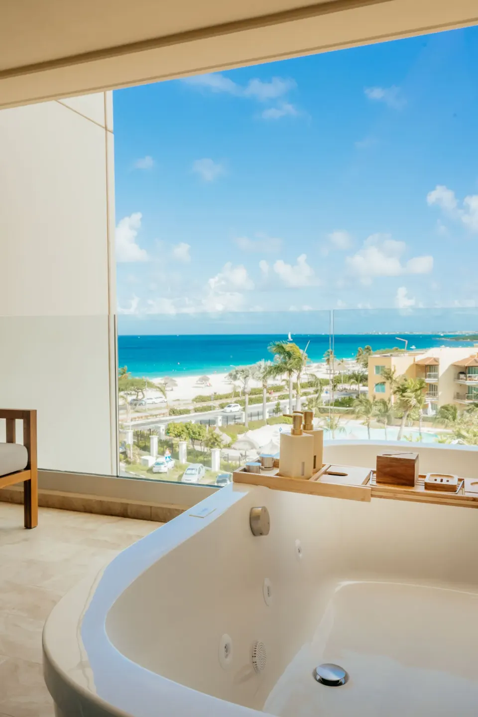 Suite balcony soaking tub with wide side ocean and beach view at JOIA Aruba.
