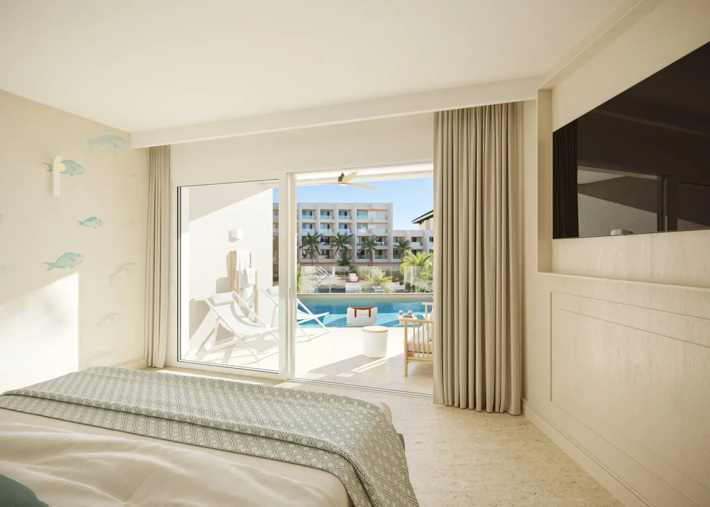 Swim-out suite bedroom with terrace and pool at JOIA Aruba.