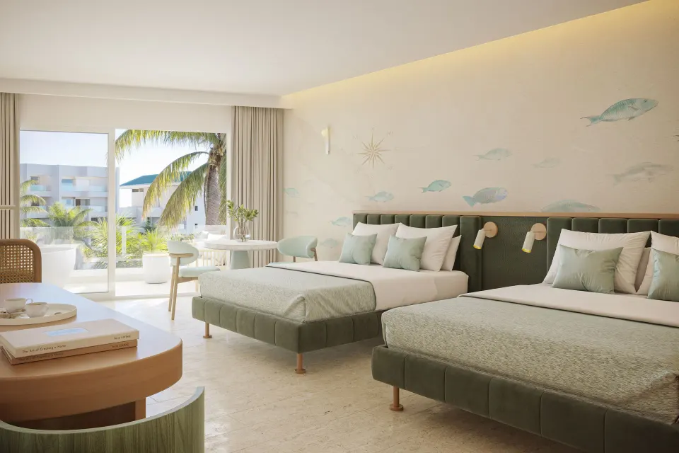 Suite with two beds, fish mural and balcony view with palms at JOIA Aruba.
