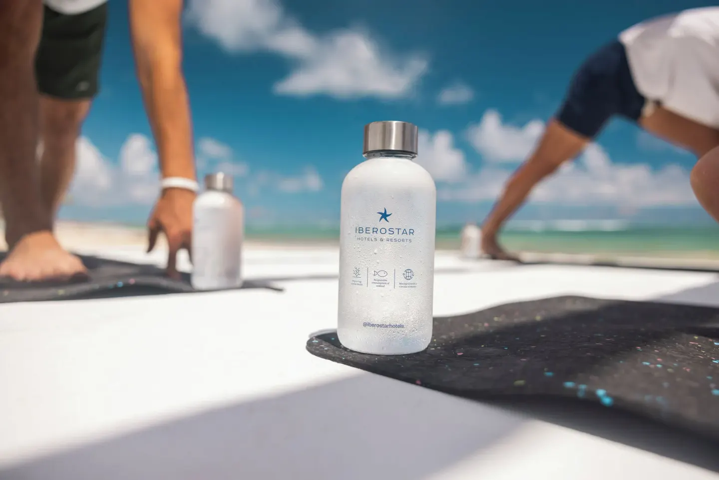 Reusable water bottle on a beach fitness mat at JOIA Bávaro by Iberostar.