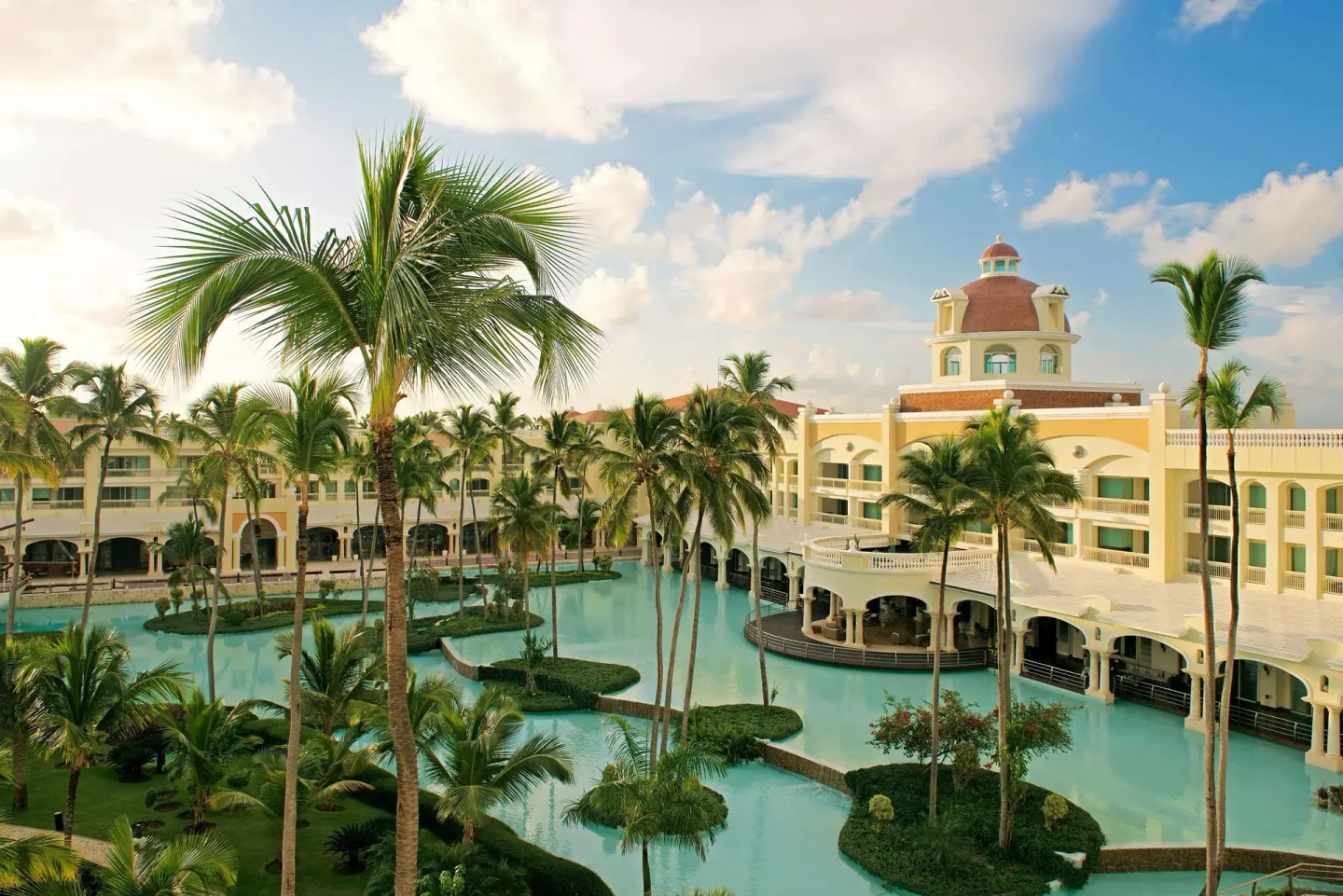 Lagoon-style waterways and resort buildings at JOIA Bávaro by Iberostar.