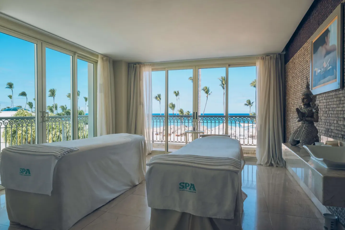 Spa treatment room with two massage tables and ocean view at JOIA Bávaro by Iberostar.
