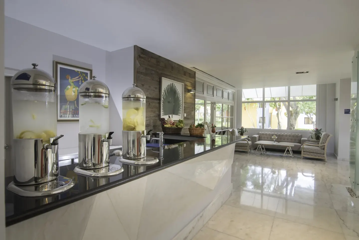 Spa refreshment counter with fruit water and lounge seating at JOIA Bávaro by Iberostar.