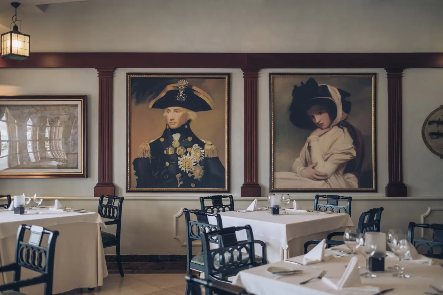 Portrait-lined restaurant dining room at JOIA Bávaro by Iberostar.