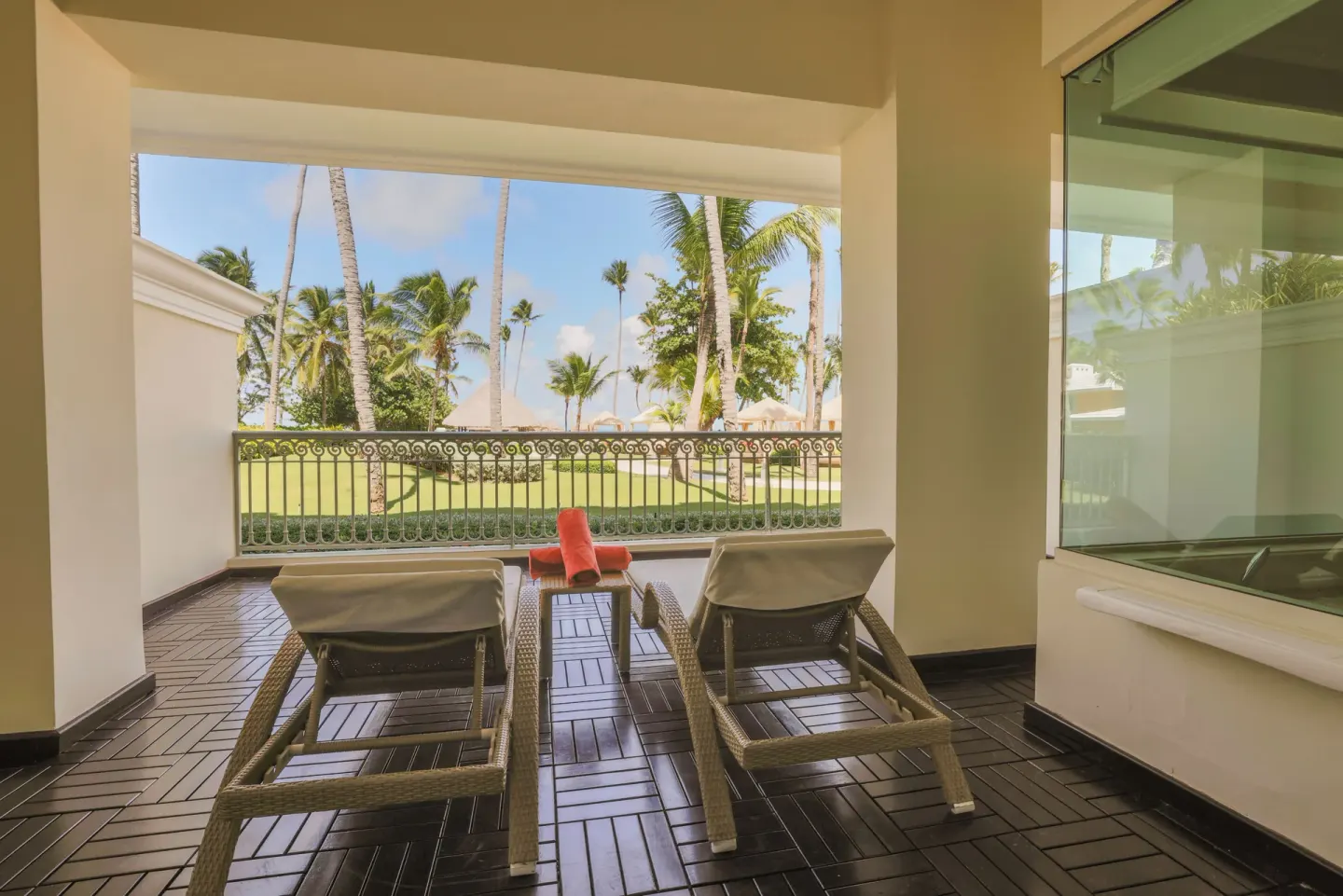Beachside suite terrace with two loungers and palm views at JOIA Bávaro by Iberostar.