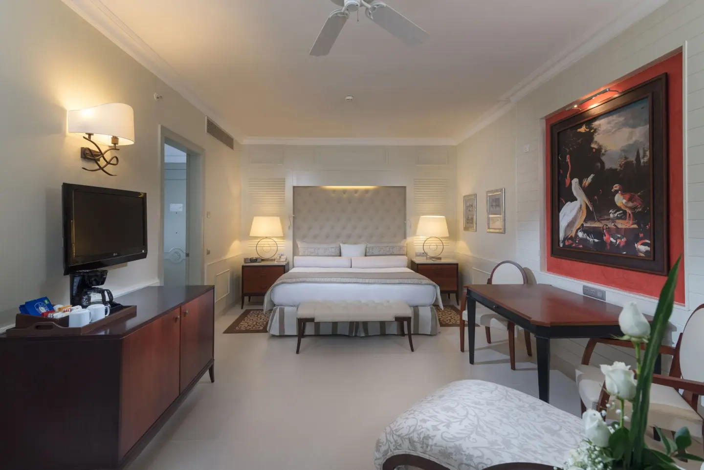 Swim Out suite bedroom with king bed and seating at JOIA Bávaro by Iberostar.