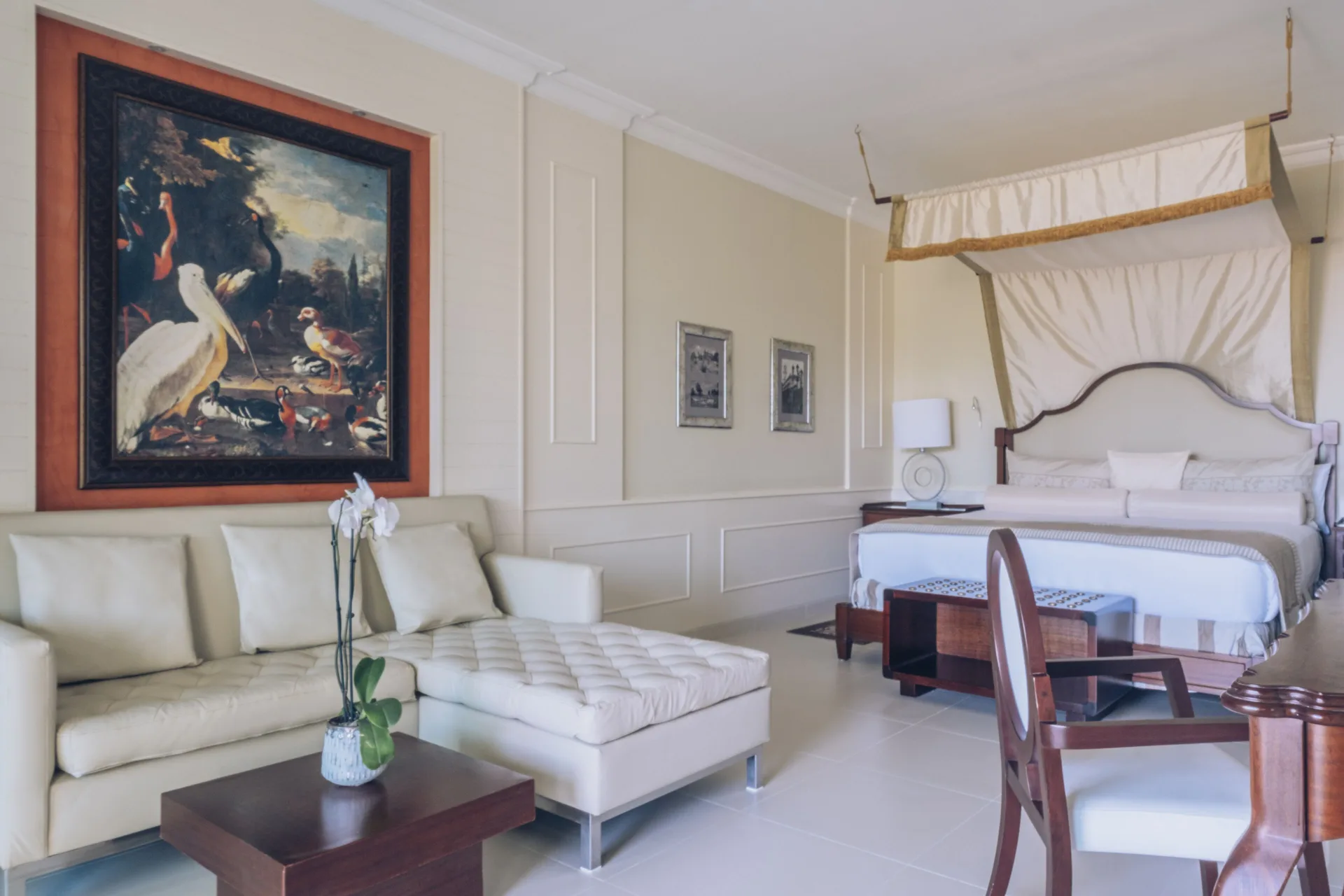 Oceanfront suite with canopy bed and sofa at JOIA Bávaro by Iberostar.