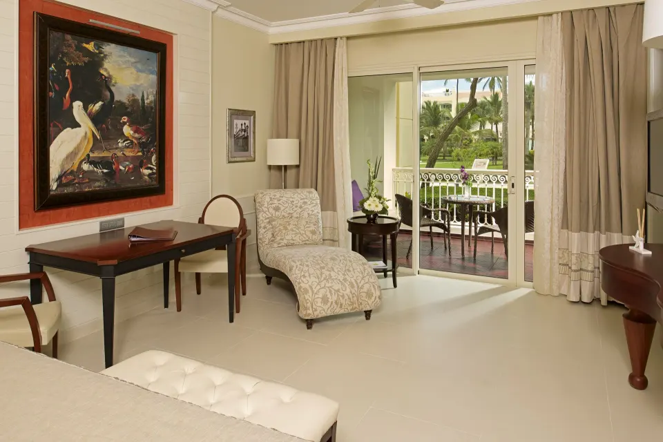 Suite upper floor sitting area and balcony at JOIA Bávaro by Iberostar.