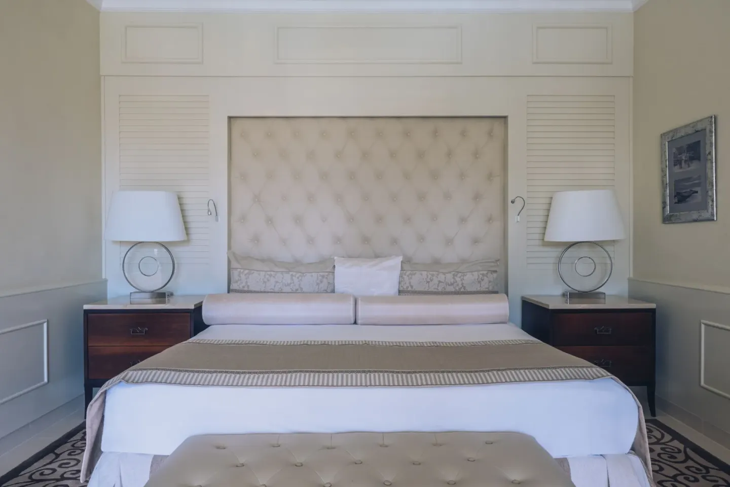 Suite king bed with tufted headboard and matching nightstands at JOIA Bávaro by Iberostar.